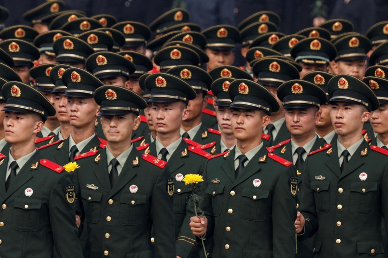 Members of China's military attend a wreath laying ceremony on Tiananmen Square to mark Martyrs' Day on the eve of the National Day in Beijing, China September 30, 2022. REUTERS/Thomas Peter