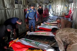 The bodies of Iraq's federal police members who were killed in suspected IS attack, are repatriated from Kirkuk airport in northern Iraq on December 18, 2022. - Gunmen in northern Iraq where remnants of the Islamic State group are active blew up a vehicle carrying policeman before opening fire killing nine, police sources said. No group immediately claimed responsibility for the attack, one of the deadliest in Iraq in recent months. (Photo by Marwan IBRAHIM / AFP)
