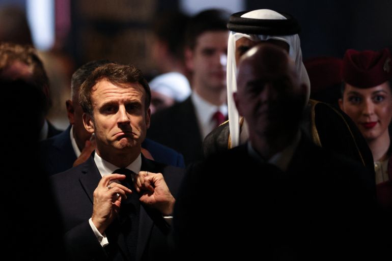 French President Emmanuel Macron (L) looks on ahead of the trophy ceremony at the end of the Qatar 2022 World Cup final football match between Argentina and France at Lusail Stadium in Lusail, north of Doha on December 18, 2022. (Photo by Adrian DENNIS / AFP)