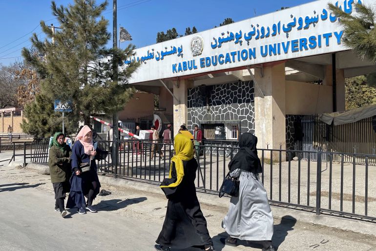 Female students walk in front of the Kabul Education University in Kabul