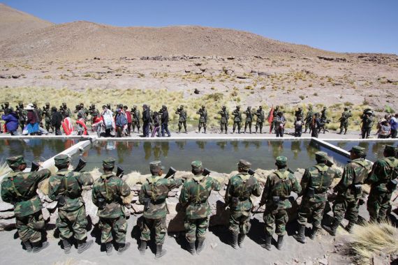Soldiers and residents attend a trout farm inauguration program by Bolivia's President Evo Morales in Silala