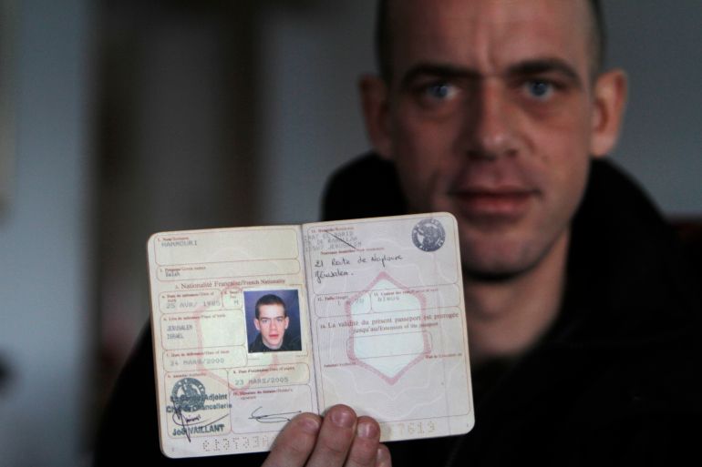 Salah Hamouri, 26, one of the 550 Palestinian prisoners freed to complete a deal in which Israel released 1,027 prisoners for soldier Gilad Shalit who was held captive in the Gaza Strip for over five years, shows his French passport during an interview with Reuters in the West Bank neighbourhood of Dahiyet al-Barid, on the outskirts of Jerusalem December 19, 2011. REUTERS/Mohamad Torokman (WEST BANK - Tags: POLITICS)