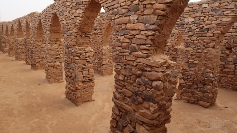 Oval door openings at the preying area of a mosque inside Ouadane Ruins in the Mauritania Desert