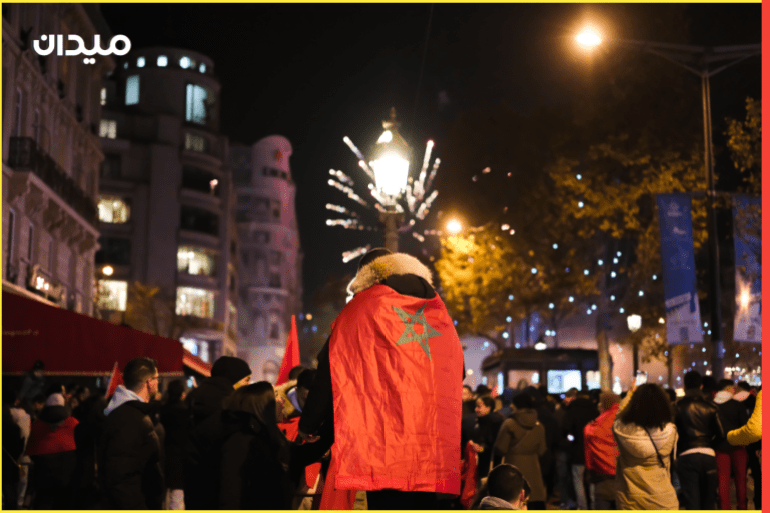 Fans of Morocco celebrate their soccer team in France- - PARIS, FRANCE - DECEMBER 10: Morocco supporters wave a Moroccan flag in the streets of Paris, France, on December 10, 2022.