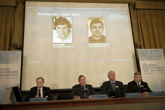 Members of the Swedish Royal Academy of Sciences in Stockholm announce on October 5, 2010 that Russian-born scientists Andre Geim (L, on screen) and Konstantin Novoselov (R) both of Manchester University, Great Britain, share the Nobel Prize in physics for pioneering work on graphene, touted as the wonder material of the 21st century. AFP PHOTO / SCANPIX - MAJA SUSLIN (Photo by MAJA SUSLIN / SCANPIX SWEDEN / AFP)