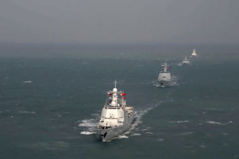 Ships sail in formation during the Russia-China naval exercise "Maritime Interaction-2022" in the East China Sea, in this still image taken from video released December 28, 2022. Russian Defence Ministry/Handout via REUTERS ATTENTION EDITORS - THIS IMAGE WAS PROVIDED BY A THIRD PARTY. NO RESALES. NO ARCHIVES. MANDATORY CREDIT. 2022-12-28T082947Z_67860940_RC2WEY95C7Z8_RTRMADP_3_RUSSIA-CHINA