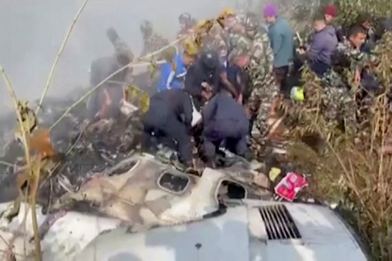 Rescuers work at the site of a plane crash in Pokhara