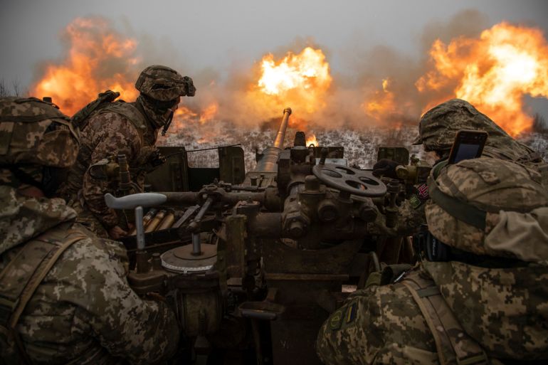 Ukrainian servicemen fire an anti-aircraft gun towards Russian positions on a frontline near the town of Bakhmut