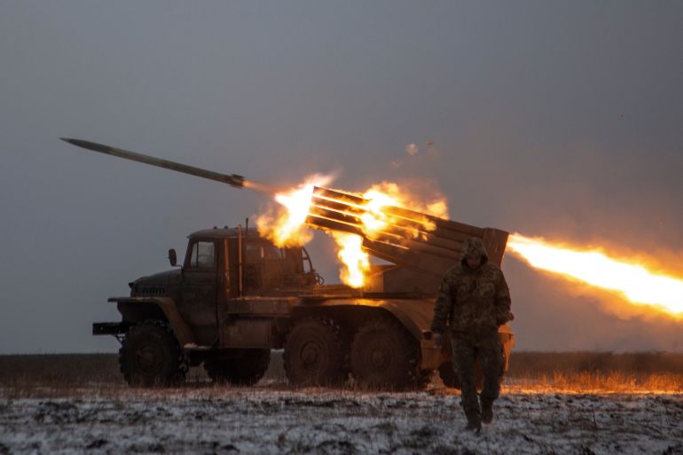 Ukrainian servicemen fire a BM-21 Grad multiple launch rocket system towards Russian positions on a frontline near the town of Bakhmut