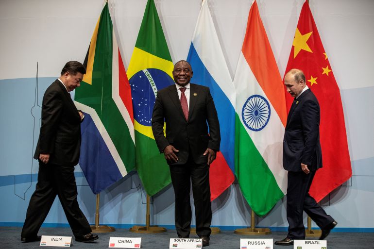 South Africa's President Cyril Ramaphosa, China's President Xi Jinping and Russia's President Vladimir Putin arrive prior to posing for a group picture at the BRICS summit meeting in Johannesburg