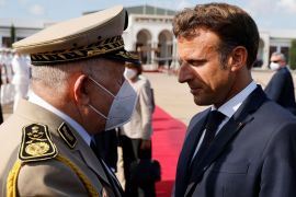 ALGERIA-FRANCE-DIPLOMACY French President Emmanuel Macron (R) meets with Algerian army chief of staff, General Said Chengriha at Algiers airport, in Algiers, on August 27, 2022. - Emmanuel Macron is on a three-day visit to Algeria aimed at mending ties with the former French colony, which this year marks its 60th anniversary of independence. (Photo by Ludovic MARIN / AFP) (Photo by LUDOVIC MARIN/AFP via Getty Images) gettyimages-1242758057