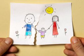 Divorce, relationship difficulties, child problems. - stock photo A child's drawing, which depicts a mom, dad and a child, is torn in half by man's hands. Divorce, relationship difficulties, child problems. gettyimages-1341770500