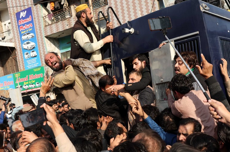 epa10488337 Supporters of opposition political party Pakistan Tehreek-e-Insaf (PTI) react from a police van during a 'Jail Bharo Tehreek' (voluntary court arrest) as PTI kickstarts the countrywide voluntary court arrest movement, in Rawalpindi, Pakistan, 24 February 2023. PTI has launched a campaign to protest what it views as an attack on its rights and the nation's economic decline under the PDM government. Former Prime Minister Imran Khan made the announcement on 22 February via Twitter, saying the voluntary court arrest movement is a non-violent protest aimed at countering alleged constitutional violations. EPA-EFE/SOHAIL SHAHZAD