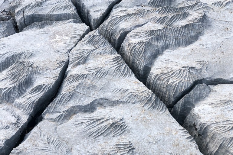 GettyImages-1357458340 Changes, sharpness, formations, crevices, corrugated and sharp structures in stones - stock photo Changes and formations in limestones in high mountains in the Mediterranean region -Antalya-Türkiye
