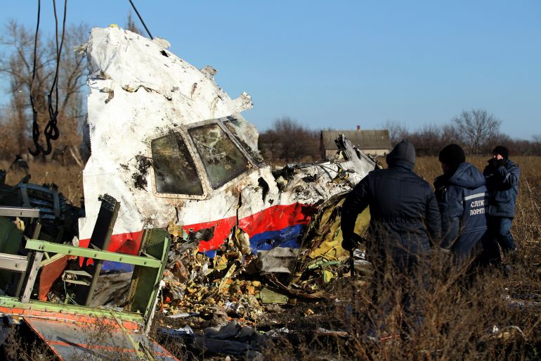 Local workers transport a piece of wreckage from Malaysia Airlines flight MH17 at the site of the plane crash near the village of Hrabove (Grabovo) in Donetsk region