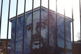 A mural of Manchester City manager Pep Guardiola is seen after Manchester City were charged with breaking financial rules by the Premier League