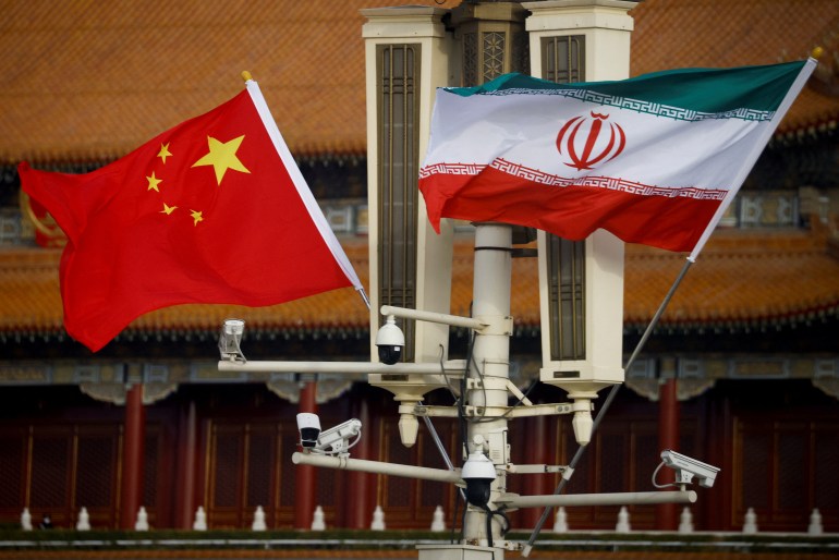 Flags of China and Iran fly in Tiananmen Square during Iranian President Raisi's visit to Beijing