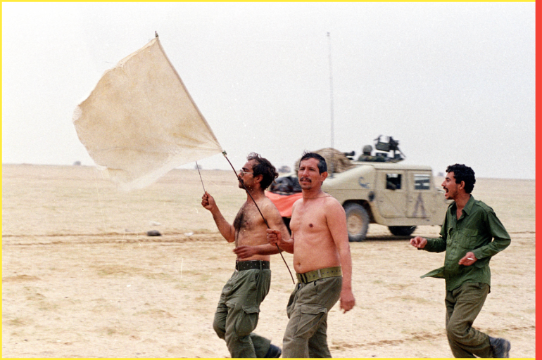 Iraqi soldiers hold a white flag as they surrender to the Egyptian army during a ground battle in Kuwait on February 25, 1991. REUTERS/Philippe Wojazer ME
