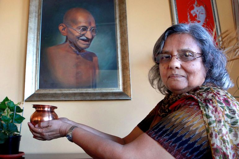 Ela Gandhi, the granddaughter of India's spiritual and political icon Mahatma Gandhi, holds some of the Gandhi's ashes in Durban on January 24, 2010. Gandhi's ashes will be immersed in the Indian Ocean after a Durban family preserved the ashes for 62 years. The ashes will be reimmersed on January 30, 2010, the day Gandhi was shot 62 years ago. The ashes will be taken to the Phoenix Bhambayi Gandhi Settlement, where Gandhi spent 21 years of his life in South Africa. Hundreds of millions of people will pay respects and honor the role of Mahatma Gandhi as India celebrates its 62nd Republic Day Celebrations on January 26, 2010. AFP PHOTO RAJESH JANTILAL (Photo by RAJESH JANTILAL / AFP)