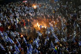 Israelis opposed to Prime Minister Benjamin Netanyahu's judicial overhaul plan set up bonfires and block a highway during a protest moments after the Israeli leader fired his defense minister, in Tel Aviv, Israel, Sunday, March 26, 2023. Defense Minister Yoav Gallant had called on Netanyahu to freeze the plan, citing deep divisions in the country and turmoil in the military. (AP Photo/Ohad Zwigenberg)