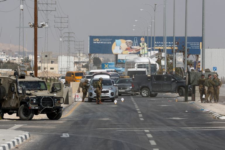 Israeli forces block off streets leading to Jericho, after suspected Palestinian gunman killed U.S.-Israeli citizen