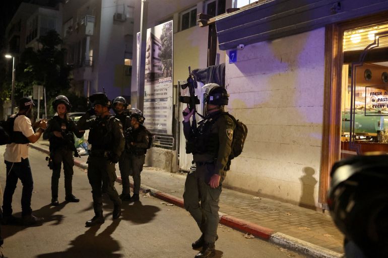 Israeli security personnel work at the scene of a suspected shooting attack in central Tel Aviv