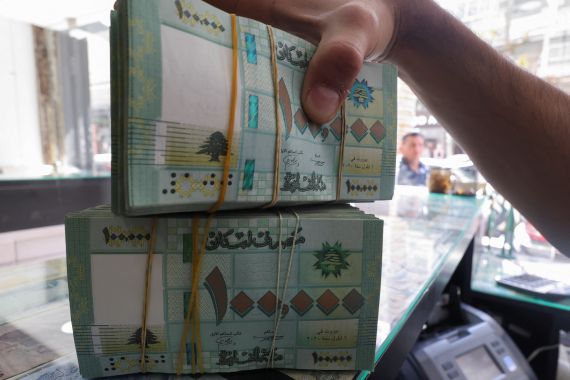 A money exchange vendor displays Lebanese pound banknotes at a shop in Beirut