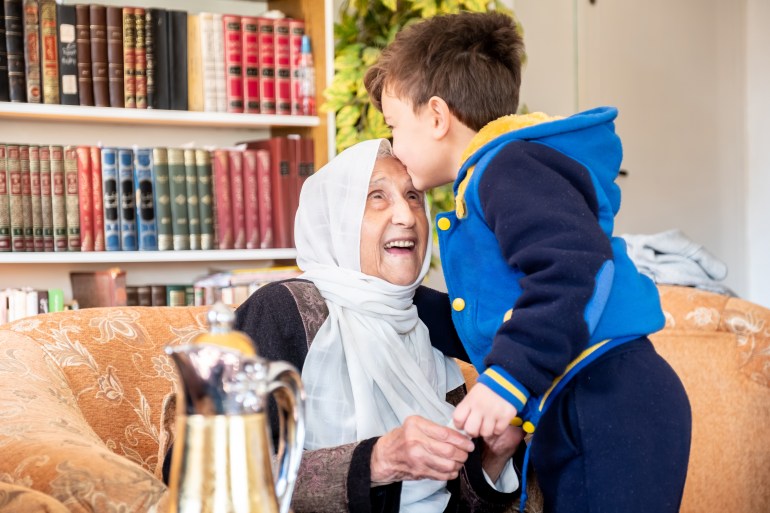 Arabic family enjoy eid celebration with grandmother while laughing together