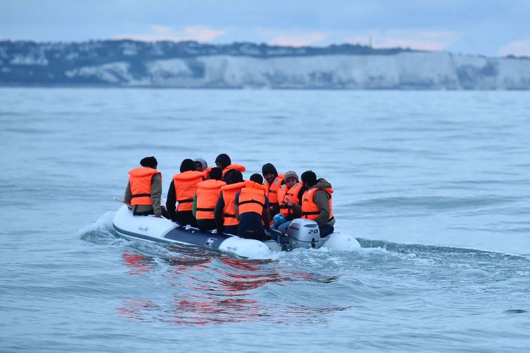 Migrants in a dinghy sail in the Channel toward the south coast of England on September 1, 2020 after crossing from France. - Migrant crossings of the Channel between France and England have hit record numbers, with thousands having arrived in small boats since the beginning of the year. The issue is politically-charged in the UK, with the country's right-wing newspapers decrying the arrivals and many ruling Conservative lawmakers calling for tougher border enforcement. (Photo by Glyn KIRK / AFP) (Photo by GLYN KIRK/AFP via Getty Images)