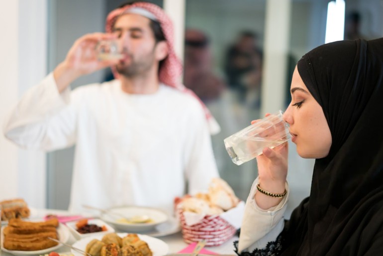 Muslim couple drinking water for breaking Ramadan fasting - stock photo Muslim family drinking water for breaking Ramadan fasting gettyimages-1209703580