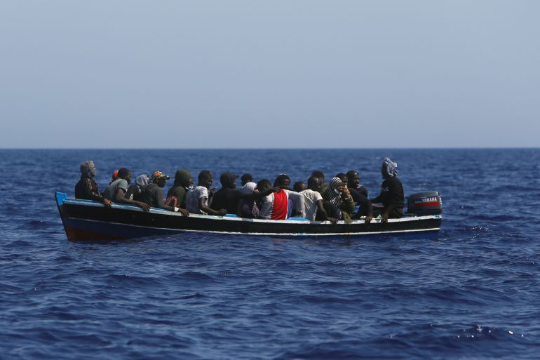 Migrants in a small wooden boat wait to be rescued by the German NGO migrant rescue ship Sea-Watch 3 in international waters off the coast of Libya, in the western Mediterranean Sea, August 1, 2021. REUTERS/Darrin Zammit Lupi