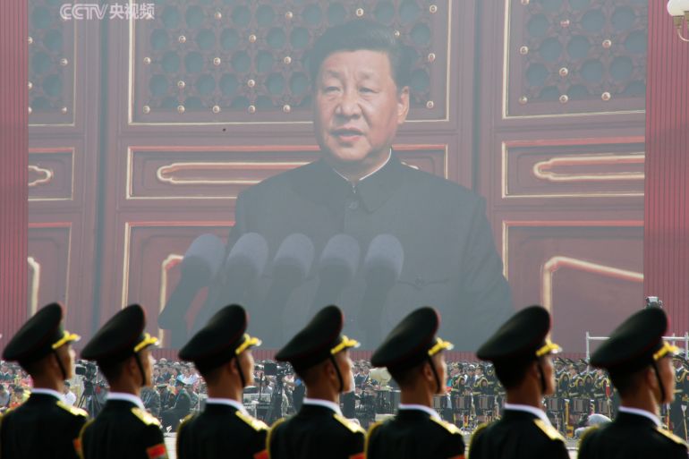 Soldiers of People's Liberation Army (PLA) are seen before a giant screen as Chinese President Xi Jinping speaks at the military parade marking the 70th founding anniversary of People's Republic of China, on its National Day in Beijing, China October 1, 2019. REUTERS/Jason Lee