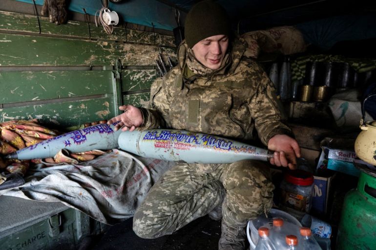 UNSPECIFIED, UKRAINE - FEBRUARY 19: Ukrainian artillery team member Mykola lifts captured 152mm shells for their 152mm cannon, which they call Revenge and captured from Russian troops in Kherson early in the war, as Ukrainian forces prepare for an expected Russian offensive, in the southern Donbas region, Ukraine, on February 19, 2023. The unit inscribes shells at the request of donors, as an incentives for those who give money to charities. Both Russian and Ukrainian forces are expecting to launch offensives soon, after a cold winter in which Russian troops and Wagner mercenaries only made incremental gains against Ukrainian units in the Donbas, as the one-year anniversary looms of Russias invasion of Ukraine on February 24. (Photo by Scott Peterson/Getty Images)