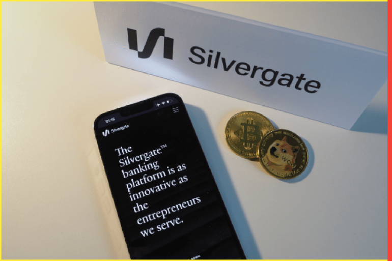 Munich, Germany Bavaria - March 11, 2023: Silvergate Capital paper logo with the logo, Bitcoin cryptocurrency, and iPhone 13 Pro website displayed. Now a bankrupt financial institution.