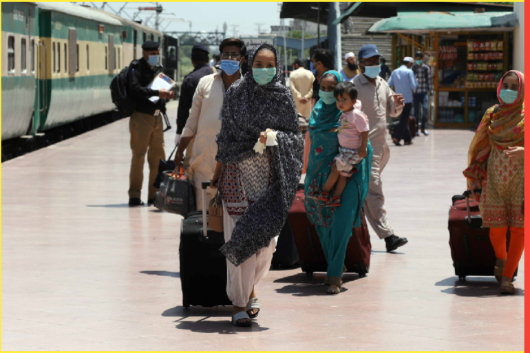 Train services resumed partially in Pakistan- - RAWALPINDI, PAKISTAN - MAY 20: Pakistani people wearing a face mask as a precaution against coronavirus (Covid-19) arrive at Rawalpindi Railways Station to board a train to leave for their hometowns to celebrate Eid al-Fitr with their families, in Rawalpindi, Pakistan on May 20, 2020. Pakistan on Wednesday partially resumed train services cross the country after being suspended for two months as the country continues to grapple with the coronavirus pandemic, resulting the death of more than 1,000 and infected coronavirus cases around 47,000.
