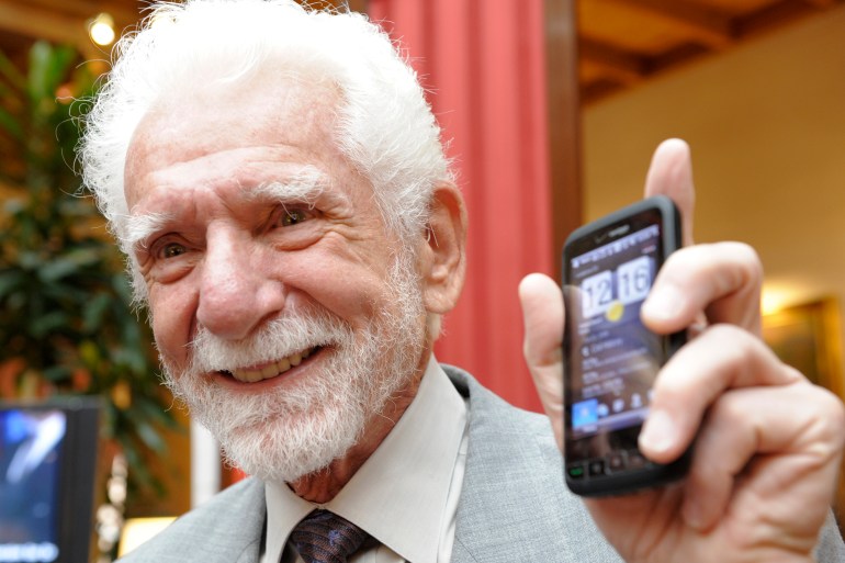 Martin Cooper holds up his mobile phone in Oviedo, northern Spain, October 22, 2009. Cooper and Raymond Samuel Tomlinson will be awarded the 2009 Prince of Asturias Award for Technical and Scientific Research at a traditional ceremony on Friday in the Asturian capital. Cooper and Tomlinson were nominated for the award in recognition of their research which led the development of the mobile phone and email respectively. QUALITY FROM SOURCE REUTERS/Felix Ordonez (SPAIN SCI TECH SOCIETY BUSINESS)