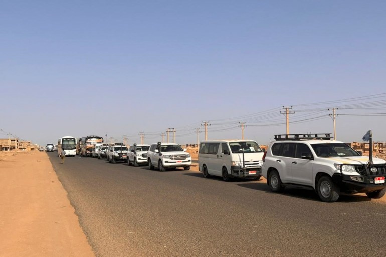 A convoy leaving Khartoum advances on a road towards Port Sudan, on April 23, 2023, as people flee the battle-torn Sudanese capital. (Photo by Abubakarr JALLOH / AFP)