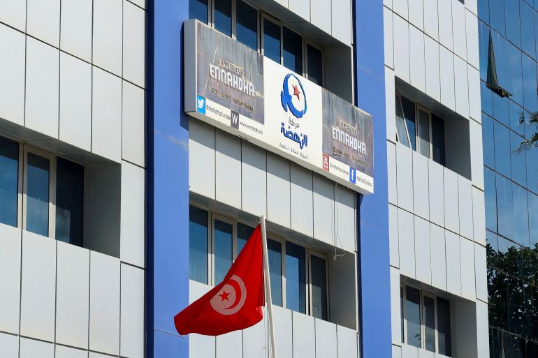 A Tunisian flag flutters outside the building of Ennahda party headquarters, in Tunis