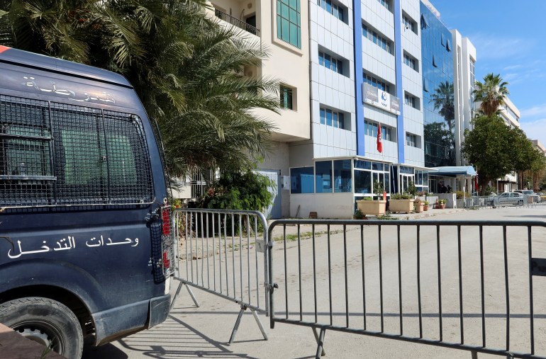 A police vehicle is parked near the building of Ennahda party headquarters, in Tunis