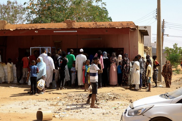 People gather to get bread in Khartoum North