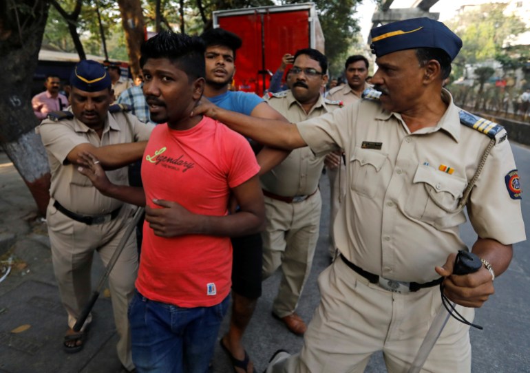 Members of the Dalit community are detained by police during a protest in Mumbai