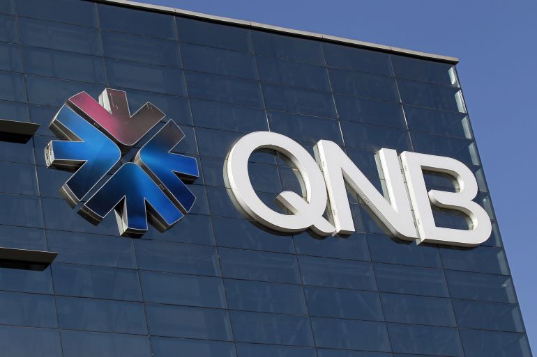 The logo of Qatar National Bank is seen on its building in Doha