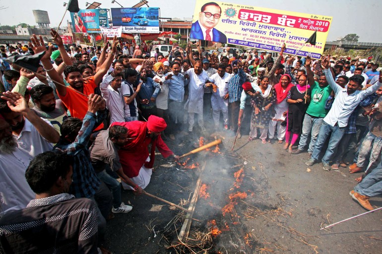 People belonging to the Dalit community shout slogans as they burn an effigy depicting India's Prime Minister Narendra Modi during a nationwide strike called by Dalit organisations, in Amritsar