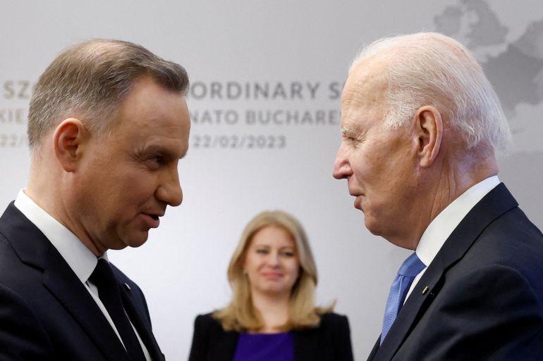 Poland's President Andrzej Duda greets U.S. President Joe Biden next to Slovakia's President Zuzana Caputova, on the day of the NATO Bucharest Nine (B9) Summit, during Biden's visit to Poland to mark the first anniversary of Russia's invasion of Ukraine, at the Presidential Palace in Warsaw, Poland, February 22, 2023. REUTERS/Evelyn Hockstein TPX IMAGES OF THE DAY