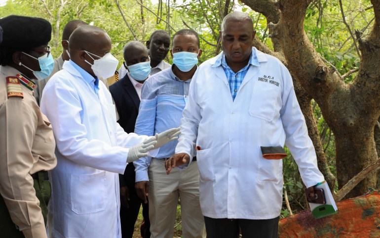 Kenya's Interior Minister Kithure Kindiki talks to forensic experts and homicide detectives from the Directorate of Criminal Investigations (DCI), as they prepare to exhume bodies of suspected followers of a Christian cult named as "Good News International Church"who believed they would go to heaven if they starved themselves to death, in Shakahola forest of Kilifi county, Kenya May 9, 2023. REUTERS/Stringer