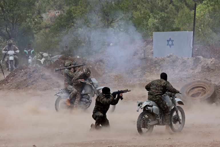 Lebanese Hezbollah fighters take part in cross-border raids, part of large-scale military exercise, in Aaramta bordering Israel on May 21, 2023 ahead of the anniversary of Israel's withdrawal from southern Lebanon in 2000. (Photo by ANWAR AMRO / AFP)