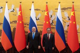 Russian Prime Minister Mikhail Mishustin and Chinese Premier Li Qiang attend a signing ceremony in Beijing