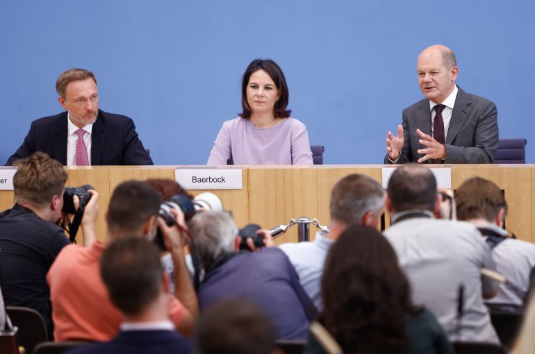 German Chancellor Olaf Scholz (R) speaks during a press conference with German Foreign Minister Annalena Baerbock (C) and German Finance Minister Christian Lindner on June 14, 2023 to present the German government's national security strategy for the country (Photo by MICHELE TANTUSSI / AFP)