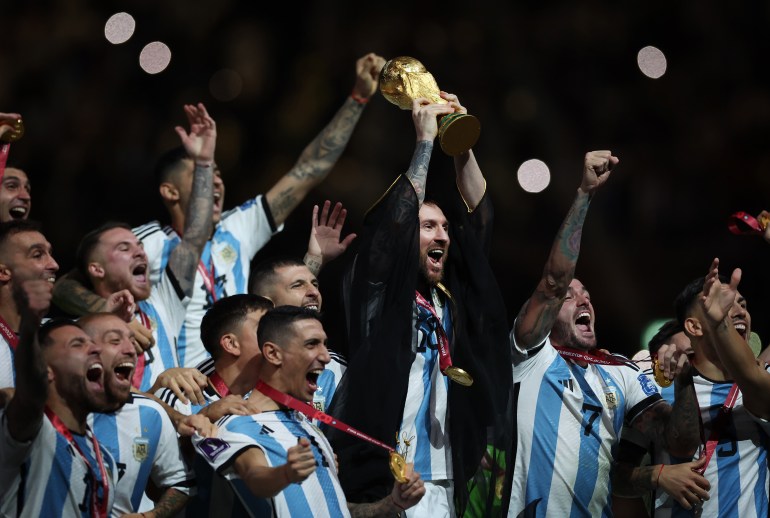 LUSAIL CITY, QATAR - DECEMBER 18: Lionel Messi of Argentina holds the World Cup Trophy aloft during the FIFA World Cup Qatar 2022 Final match between Argentina and France at Lusail Stadium on December 18, 2022 in Lusail City, Qatar. (Photo by Ian MacNicol/Getty Images)