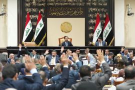 Iraqi lawmakers attend a parliamentary session to vote on the federal budget at the parliament headquarters in Baghdad